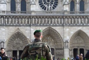 A French soldier patrols next to the Notre-Dame cathedral in Paris on December 24, 2015 as part of security measures set following the November 13 Paris terror attacks. / AFP / DOMINIQUE FAGET        (Photo credit should read DOMINIQUE FAGET/AFP/Getty Images)